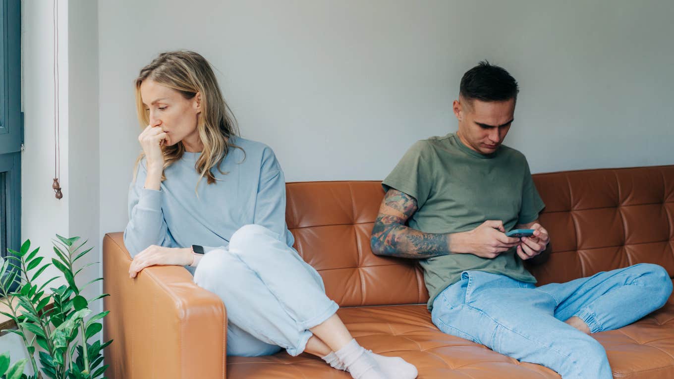 couple on couch disconnected because of technology