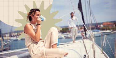 Woman enjoying a cup of coffee on a sail boat with her partner