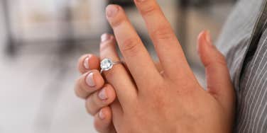 woman taking off wedding ring